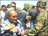 سرباز ازبکستان هنگام بازرسی اوراق يکی از اهالی قره سو