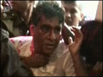 Minister Mervyn Silva being escorted from SLRC by security forces