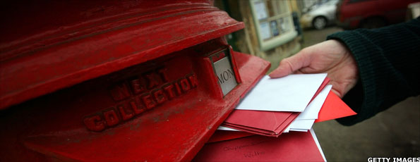 Hand posting letters in letterbox
