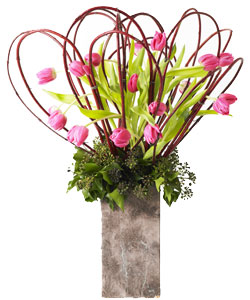 tulips, cornus and berried tree ivy in tall vase