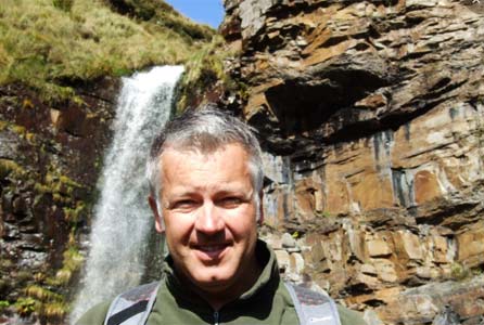 Derek next to a waterfall in the Rhondda