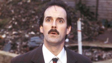 John Cleese as Basil Fawlty