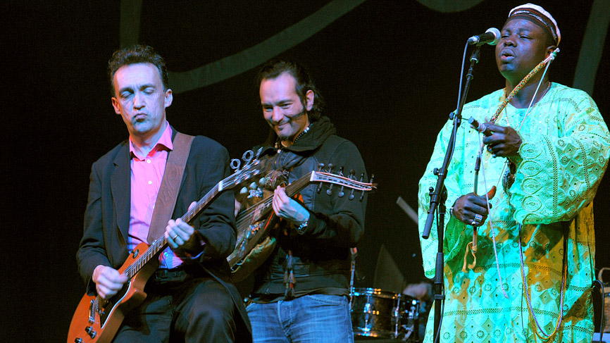 Justin Adams with Juldeh Camara live at the Old Fruitmarket. Photo by Louis Decarlo