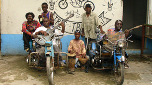 Staff Benda Bilili on their customised wheelchairs