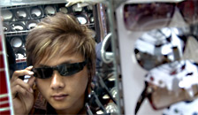 Man trying on sunglasses from a sunglasses display