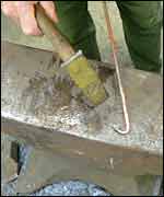 A blacksmith hammering steel
