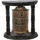 Prayer wheel, a cylinder of metal decorated with Buddhist mantras, designed to turn freely on its vertical axis