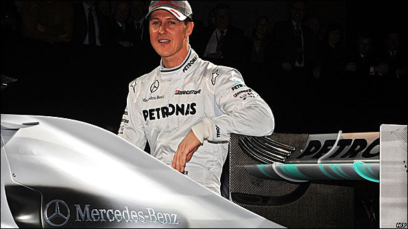 Michael Schumacher poses with a 2009 Brawn car in Mercedes's 2010 colours at the German marque's F1 launch in Stuttgart