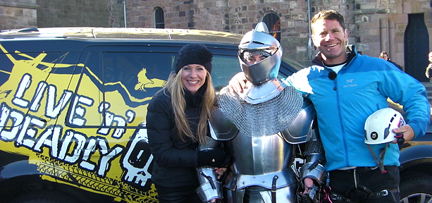 Steve Backshall and Naomi Wilkinson standing with a knight