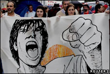 People hold a banner saying "IMF hunger, misery, injustice", during a demonstration in Lisbon, Portugal
