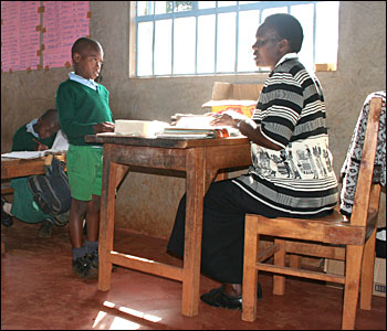 at teacher's desk