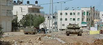 Israeli tanks stand guard at the entrance to Yasir Arafat's compound in Ramallah.