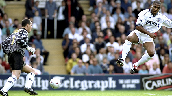 Neil Sullivan, in action for Wimbledon, makes a save to deny Tottenham's Les Ferdinand. 