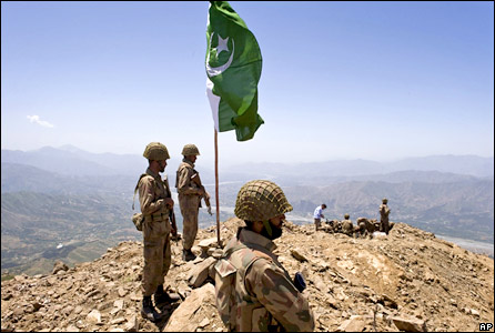 A Pakistani flag flies over government troops installed on top of a defence position on a former base of Taliban militants overlooking the Swat Valley