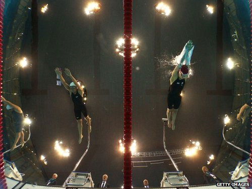 Dong Lu of China and Nyree Kindred of Great Britain compete in the Women's 100m Backstroke 