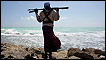 A Somali pirate looks out to sea
