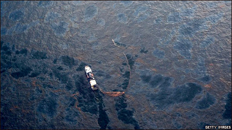 A boat works to collect oil that has leaked from the Deepwater Horizon wellhead in the Gulf of Mexico on April 28, 2010