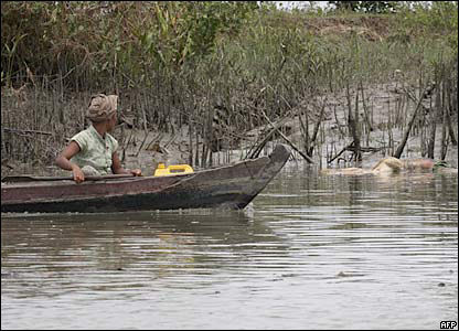 A boat passes bodies in the Irrawadday delta
