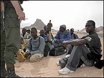 Algerian border guards watching migrants