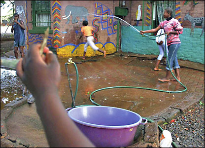 Children making a splash in the grounds of the Amazing Grace Children's Centre