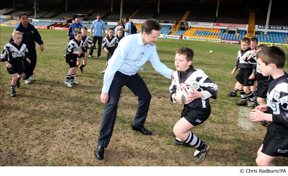 Nick Clegg plays tag rugby against the Leeds Rhinos under 10s during a visit to the club
