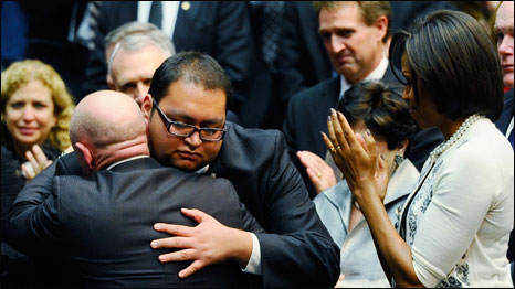 Daniel Hernandez Junior - an intern of US Congresswoman Gabrielle Giffords - hugs Gifford's husband, NASA astronaut Mark Kelly, as first lady Michelle Obama looks on. Photo: Kevork Djansezian/Getty Images)