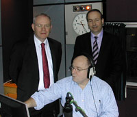 Irish Foreign Minister Micheal Martin (back, right), Deputy First Minister, Martin McGuinness (back left), with Paul McFadden, on air.