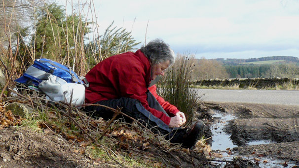 Hillwalker adjusting her boots