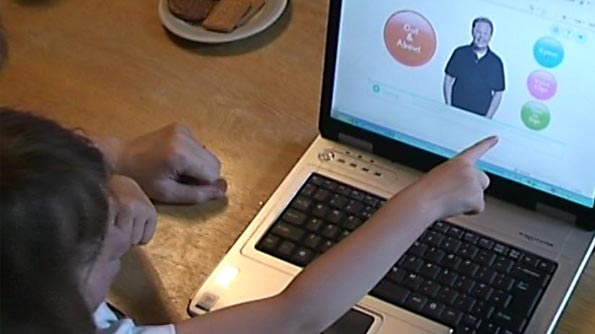 Young girl pointing at a prototype of Out and About