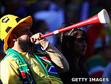 Man blowing a vuvuzela