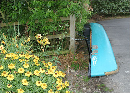 Boat chained in car park