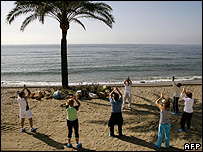 Tourists doing tai chi on Marbella beach