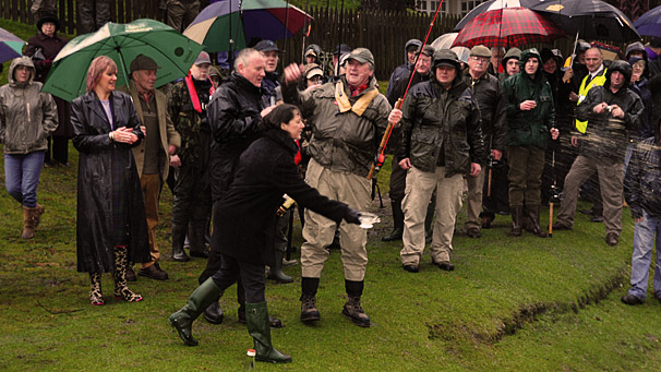 crowd gathered watching the throwing of whisky