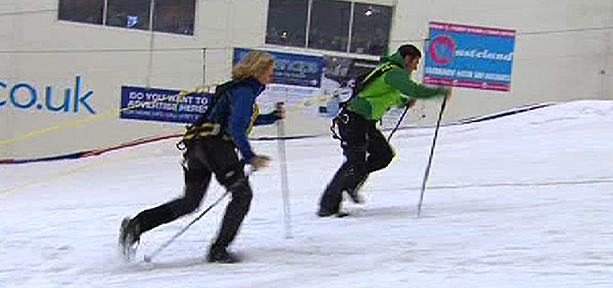 Steve Backshall racing Ann Daniels across the snow on skis