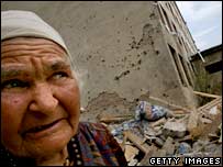 Gori'de bombalanan binaların önünde bir Gürcü kadın