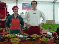 man and woman on olive stall