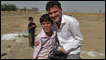 Mark Cousins (right) with child in Goptapa, Iraq