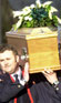 Image of postman carrying coffin