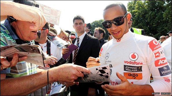 Lewis Hamilton signs autographs for fans