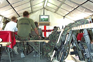 British soliders watch the World Cup between patrols