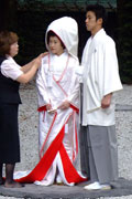 Bridegroom and bride, both wearing white