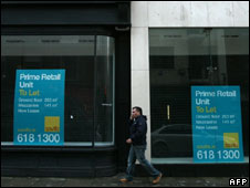 A man walks past empty shops in Dublin, 11 November