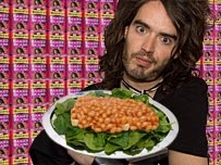 Russell Brand holding a plate of beans