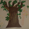 A collage of a tree with leaves made from jigsaw pieces