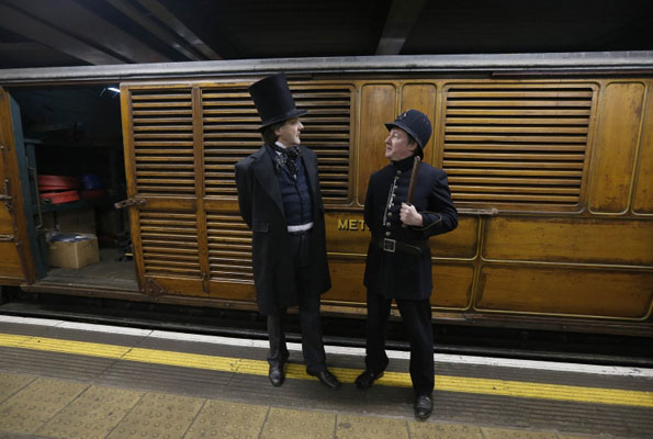 Actors stand by a vintage train