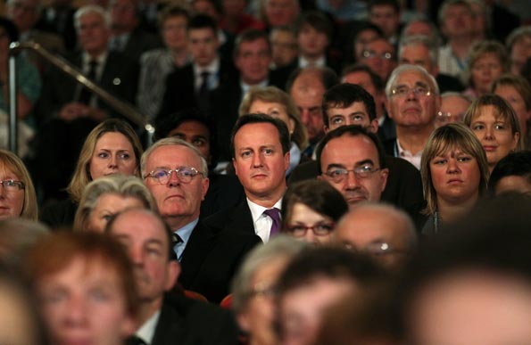 David Cameron sitting among conference delegates