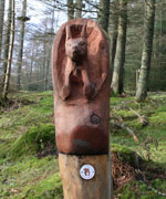 A red squirrel carved from wood at the start of Whinlatter Forest's squirrel trail