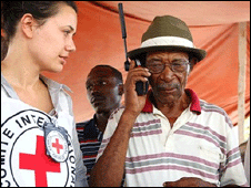 A man with the Red Cross speaks on his mobile phone (Copyright AFP)