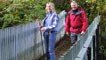 Lisa Markam and Derek Brockway crossing a footbridge