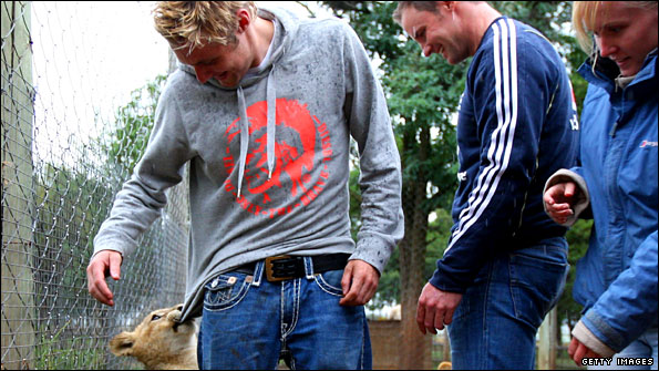 A lion cub with Luke Wright and Andrew Strauss
